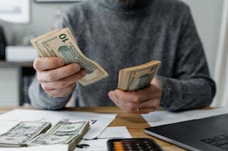 person counting side hustle earnings feeling accomplished