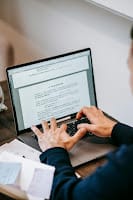 person working on side hustle from laptop at home in evening