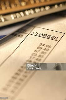Person looking at bank statement and circling subscription charges to cancel