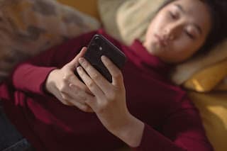 Person scrolling social media feeling inadequate about their finances