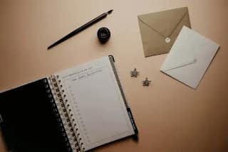 Person tracking spending and writing a list of expenses in a notebook during a no spend challenge
