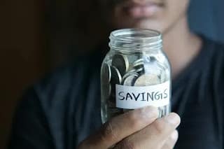 saving money in a jar happily