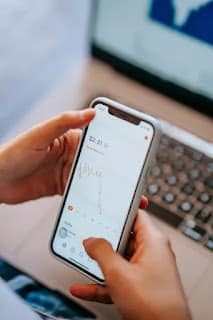 person looking at banking app with small savings growing