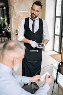 expensive restaurant bill on table representing wasted weekend money