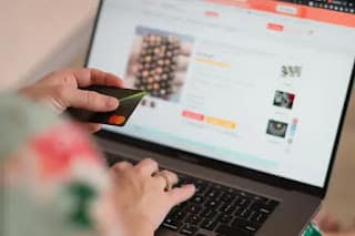 Person is being ready to buy something online with card