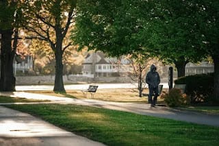 person walking alone in a park on a weekend morning feeling free
