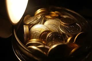 coins collecting in a jar on a kitchen counter