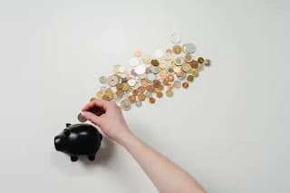 why being broke is so expensive - person counting last few dollars and coins