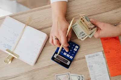 How Long Does It Actually Take to Pay Off $5,000 in Debt how long to pay off 5000 in debt - person calculating bills and credit card payments