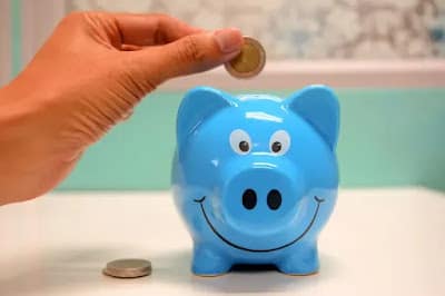 How Much Money Should You Have Saved by 25 30 and 35 how much money should you have saved by 30 - person looking at savings jar with coins